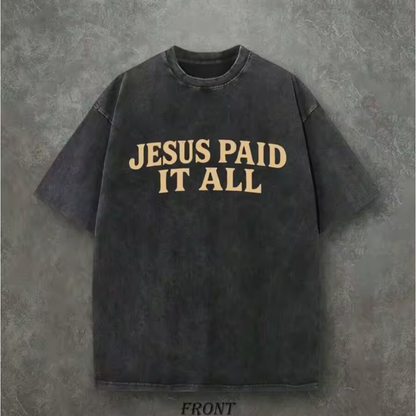 Black t-shirt with 'Jesus Paid It All' text on a gray background